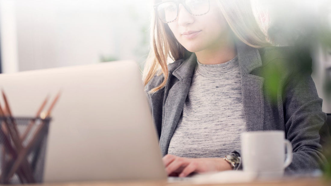 Young person working at a laptop using essential oils to help focus and concentration