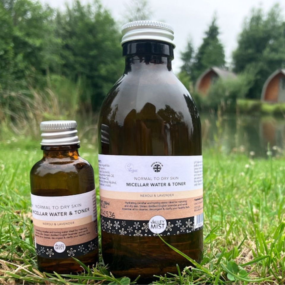 Valley Mist Neroli Micellar & Toner in 200ml and 30ml travel size, photographed outdoors in a natural lakeside setting