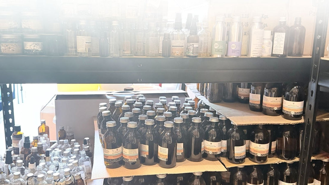 Returned Valley Mist glass bottles and jars stacked on shelves, awaiting label removal and cleaning as part of our National Glass Return System