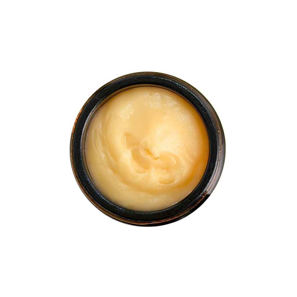 detail image of water-less body butter in amber glass jar