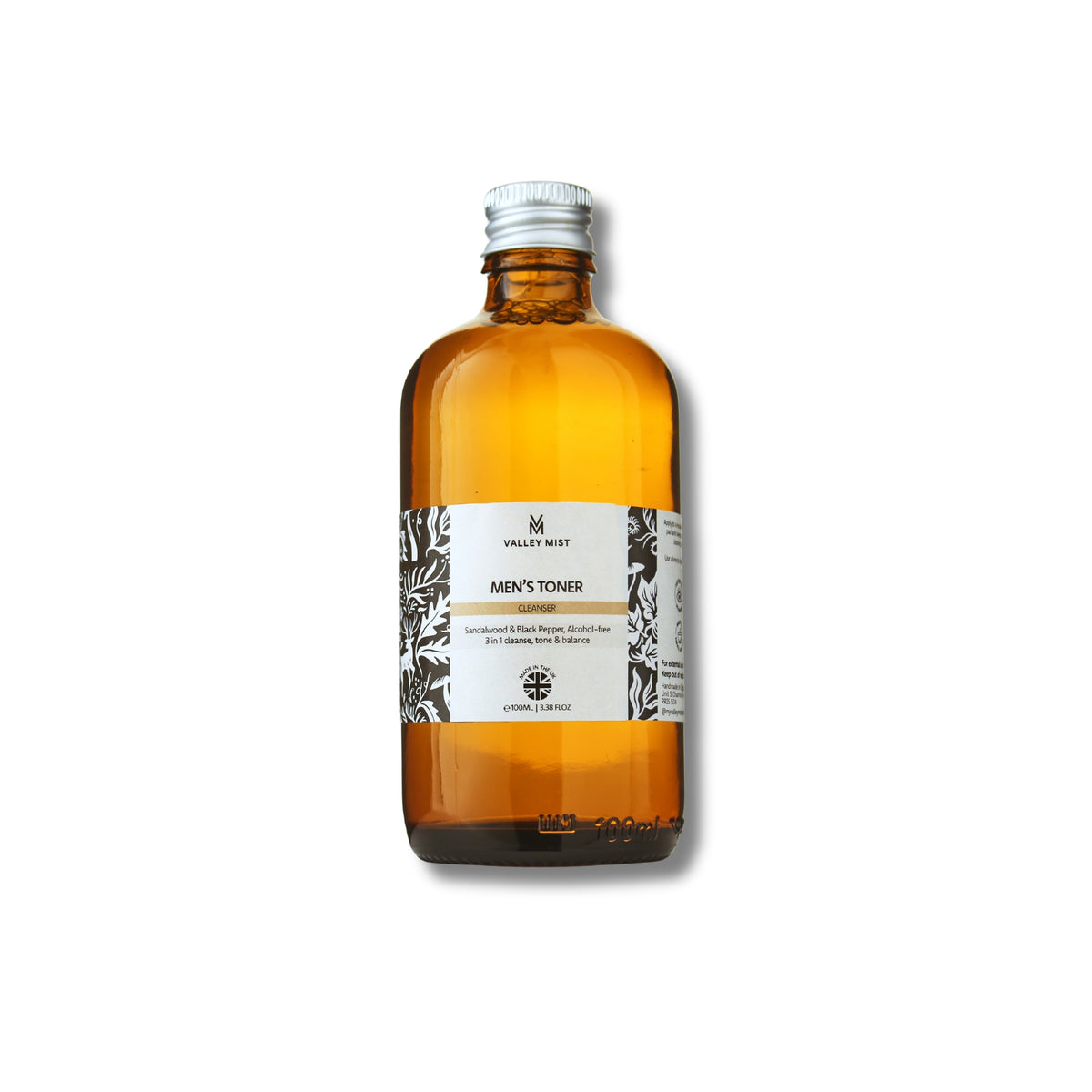A 100ml amber glass bottle of Men's Toner by Valley Mist, featuring a white label with black botanical and woodland illustrations and a silver screw cap, set against a plain white background.