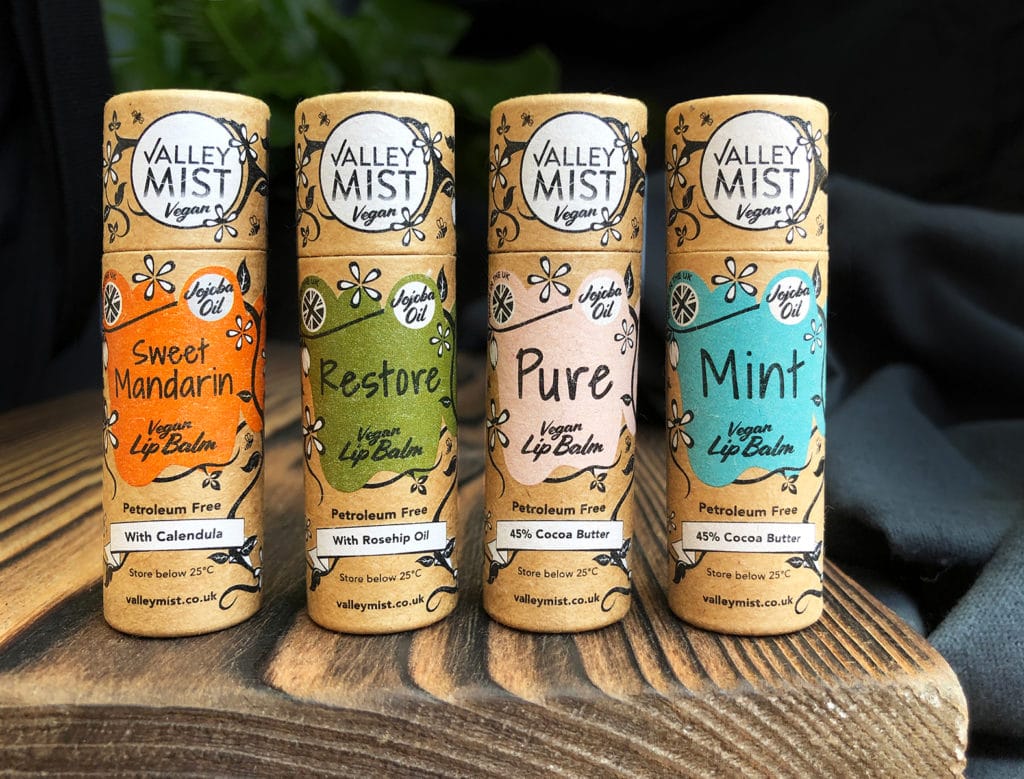 all four of the valley mist vegan lip balms in paper tubes
